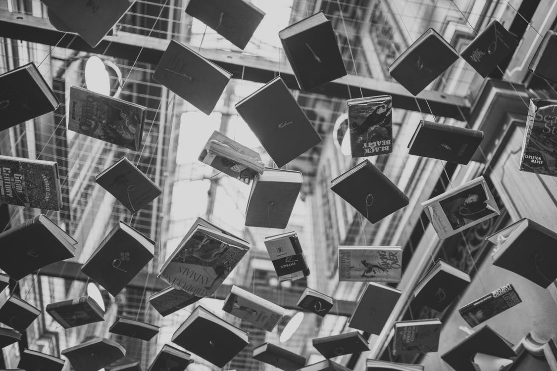 Books hanging from strings