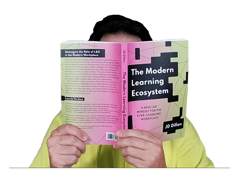 JD with his book covering his face as he reads